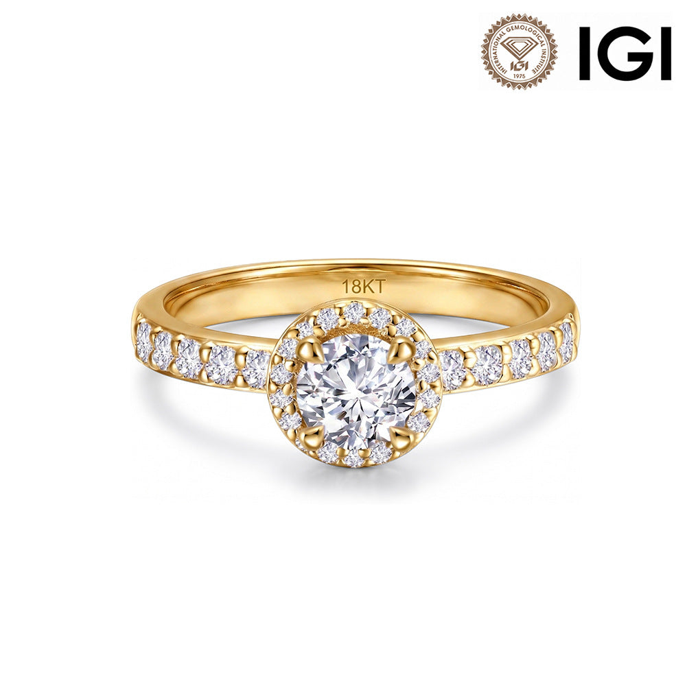 18k yellow gold round brilliant lab diamond halo engagement ring with pave band and IGI logo on white studio background
