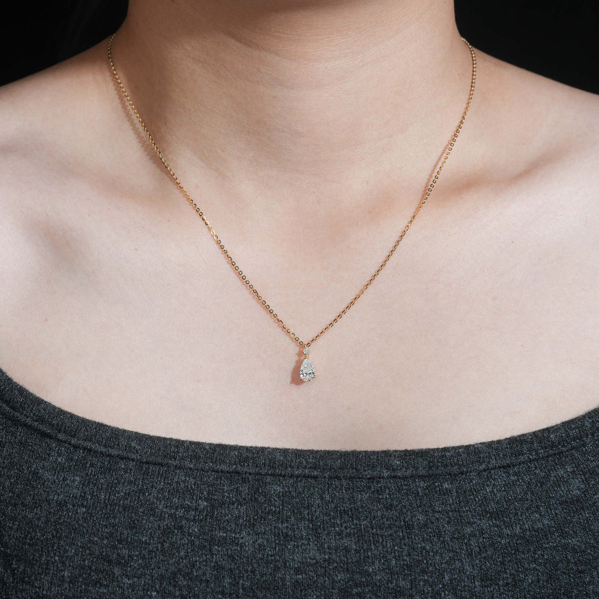 Model wearing 18k rose gold 1 carat pear cut lab-grown diamond clavicle pendant necklace