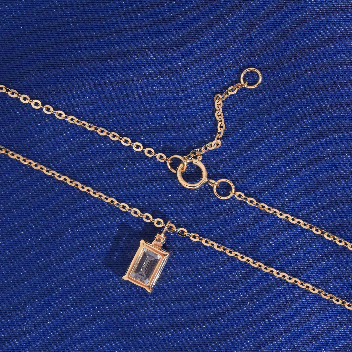 Back view of basket setting and spring ring clasp of 18k rose gold radiant cut diamond pendant necklace