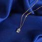 Close up view of 1 carat radiant cut lab-grown diamond in 18k rose gold setting on blue silk