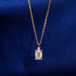 18k rose gold 1 carat radiant cut lab-grown diamond clavicle pendant necklace on royal blue silk background