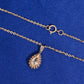 Back view of pear halo setting and spring ring clasp of 18k rose gold diamond clavicle pendant necklace