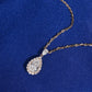 Close up view of 1 ct pear halo lab-grown diamond pendant with marquise accent in 18k rose gold