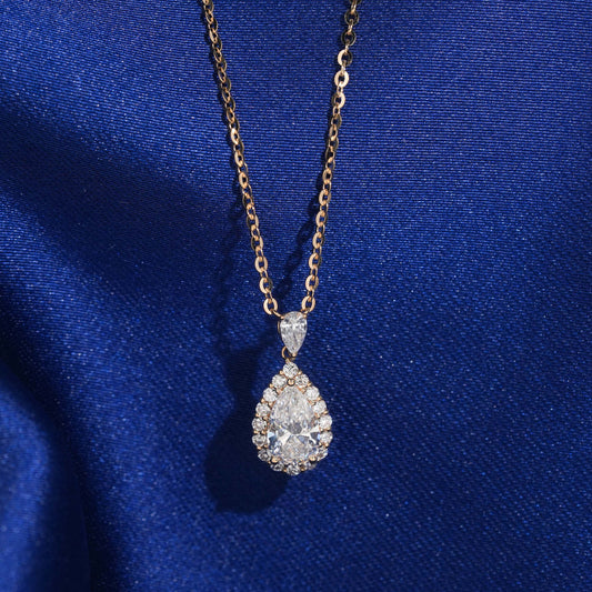18k rose gold 1 ct pear halo lab-grown diamond clavicle pendant necklace on royal blue silk background