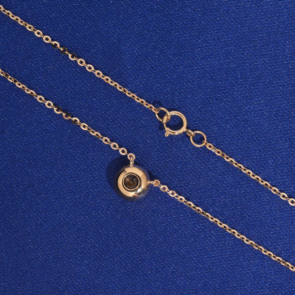 Back view of 18k rose gold 5mm bezel-set lab-grown diamond pendant and spring ring clasp