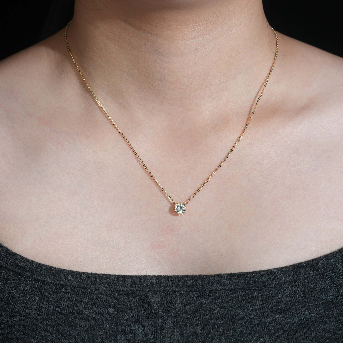 Model wearing 18k rose gold 5mm bezel-set solitaire lab-grown diamond pendant necklace