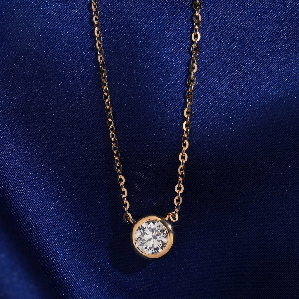 18k rose gold 5mm bezel-set solitaire lab-grown diamond pendant necklace on royal blue silk background