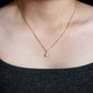 Model wearing 18k rose gold 5mm round halo lab-grown diamond clavicle pendant necklace