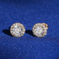 Pair of 18k rose gold 5mm round halo lab-grown diamond stud earrings standing on blue silk