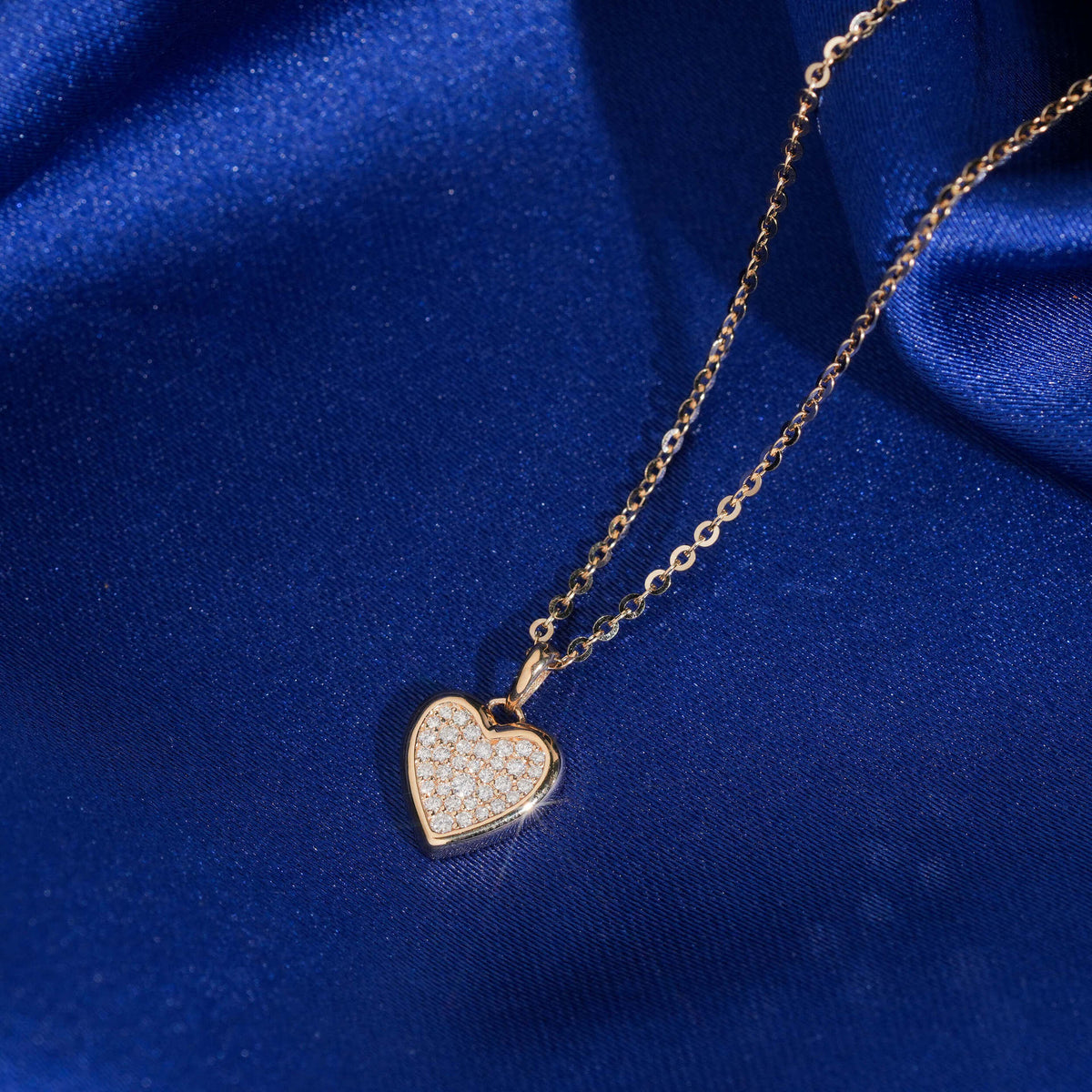 Close up view of pave setting on 18k rose gold lab-grown diamond heart pendant necklace   