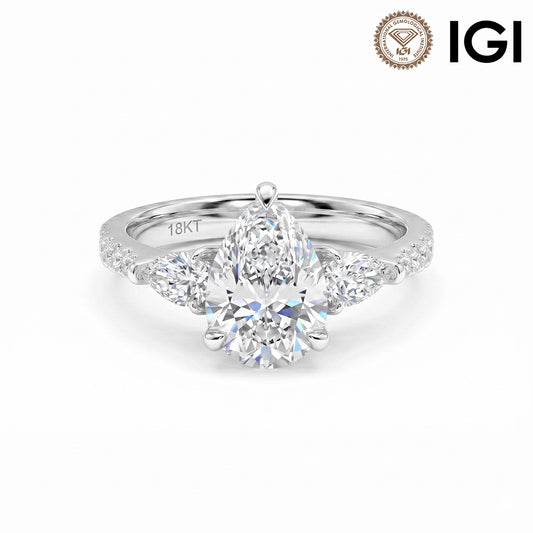 18k white gold pear shape three-stone lab-grown diamond engagement ring with pave band and IGI logo on white studio background