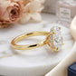 Side view profile of 18k yellow gold 2 ct oval cut lab diamond solitaire ring on white marble