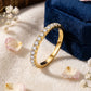 18kt yellow gold round brilliant lab diamond half eternity ring resting against blue velvet ring box   