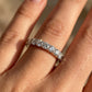 Model wearing 18kt yellow gold round brilliant lab diamond half eternity wedding ring on hand