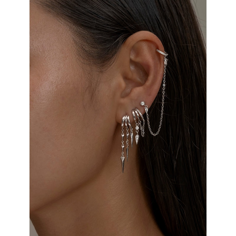 Close-up of an ear withS925 Sterling Silver Paloma Illusion Earrings and a chain accessory.