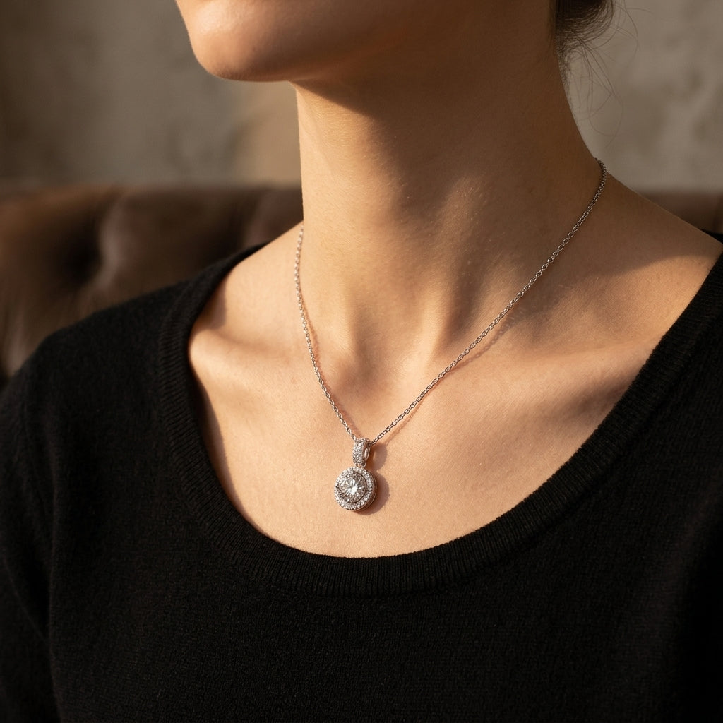 Model wearing 1ct round cut halo diamond pendant necklace with elegant black top.