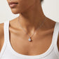 Model showing 1 carat round lab grown diamond solitaire pendant on collarbone.
