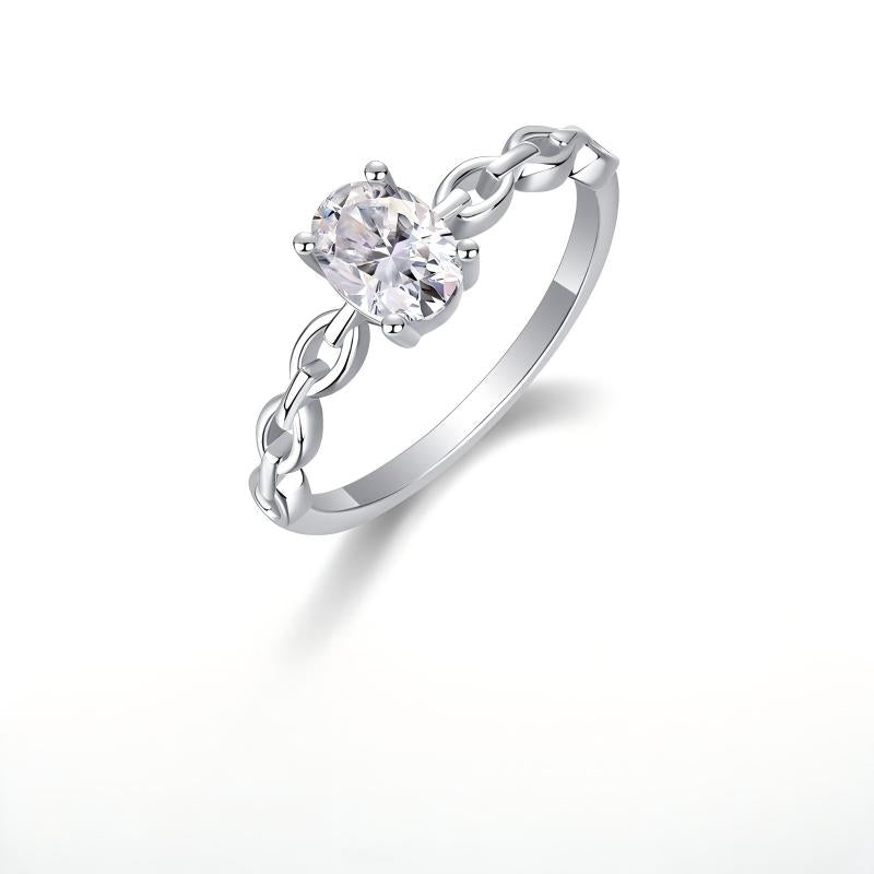 Silver 1ct oval moissanite ring with hollow chain link band standing on display.