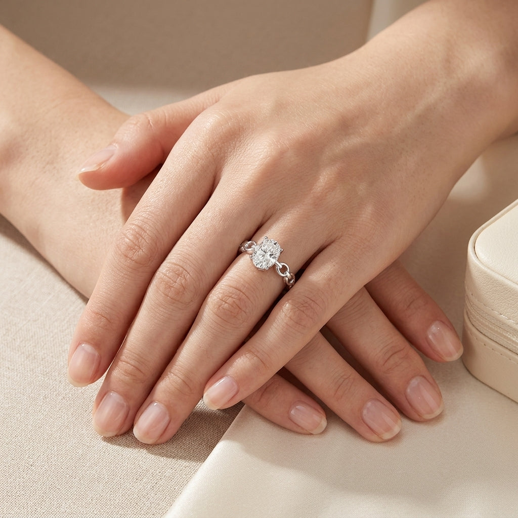 Model showing 1ct oval cut moissanite ring with chain link shank in ambient natural lighting.