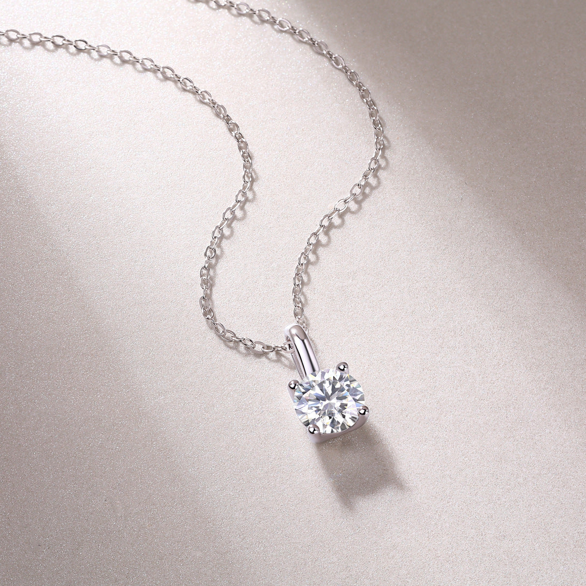 Close-up of 1 carat round brilliant lab grown diamond solitaire pendant with chain.