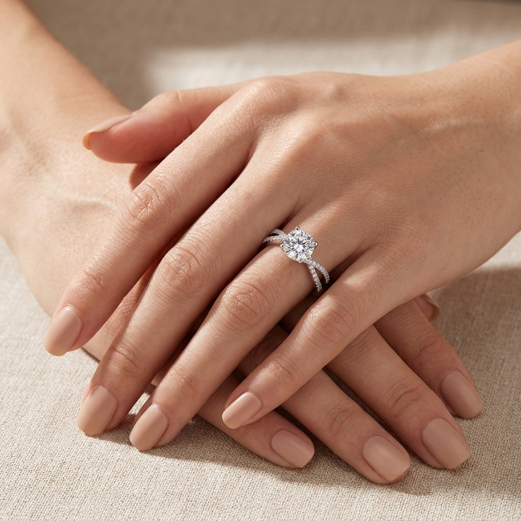 Model showing 1ct round cut moissanite crossover ring on hand in soft natural light.