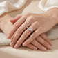 Model showing 1CT round cut moissanite three-stone engagement ring on hands in natural lighting.