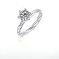 Silver 1ct round moissanite ring with twisted vine rope band standing on display.