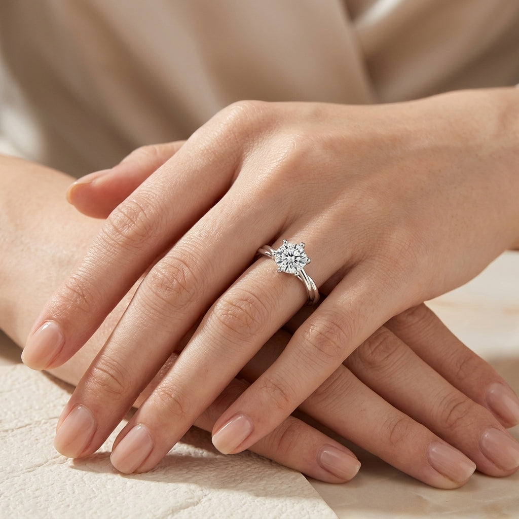 Model showing 1ct round cut moissanite 6-prong ring with twisted vine band in soft lighting.