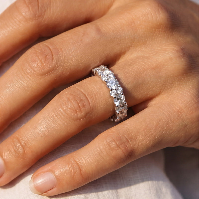 Angled profile view of 2.54ct round lab diamond double row eternity band on dark background.