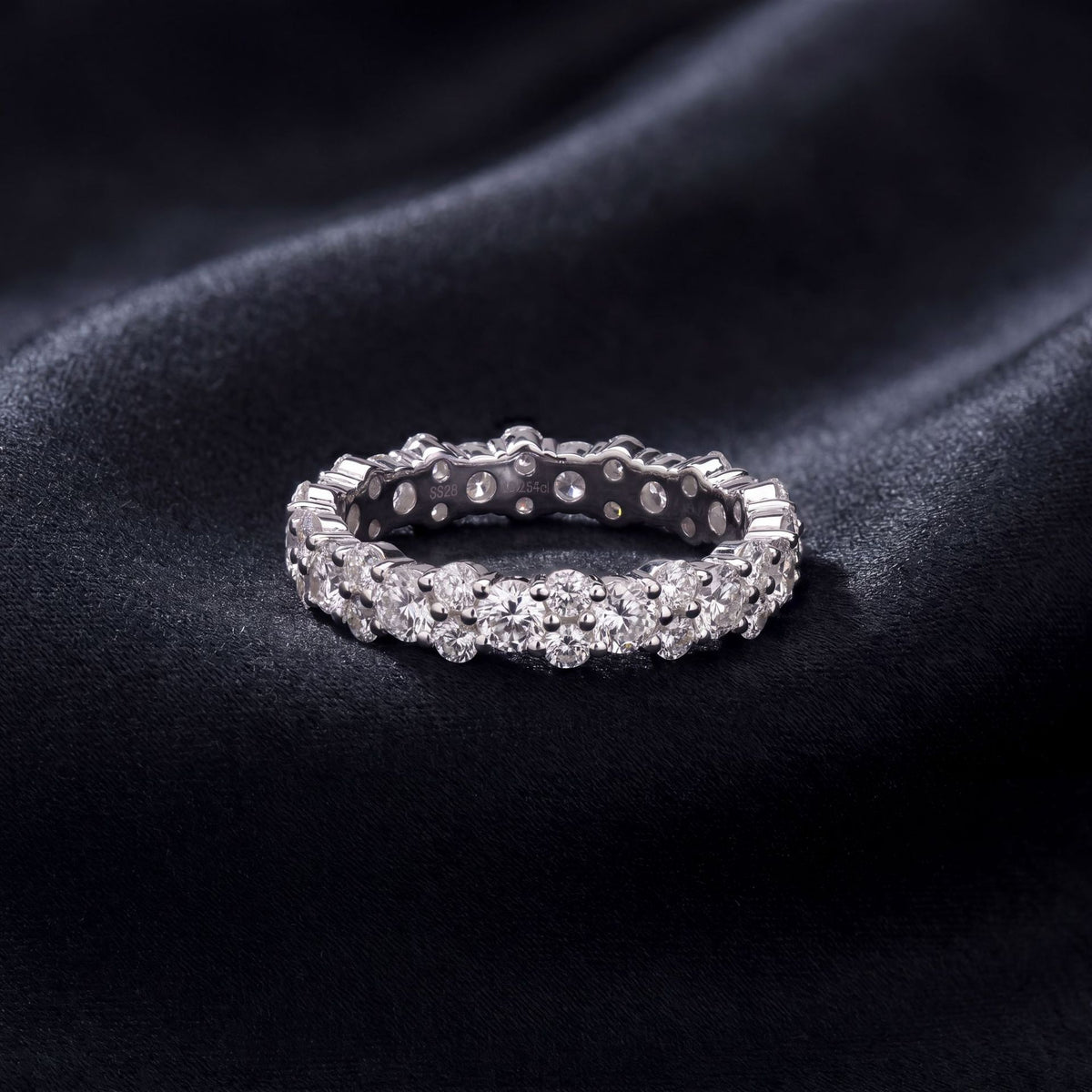 Close-up view of 2.54ct round lab diamond alternating double row ring on finger.