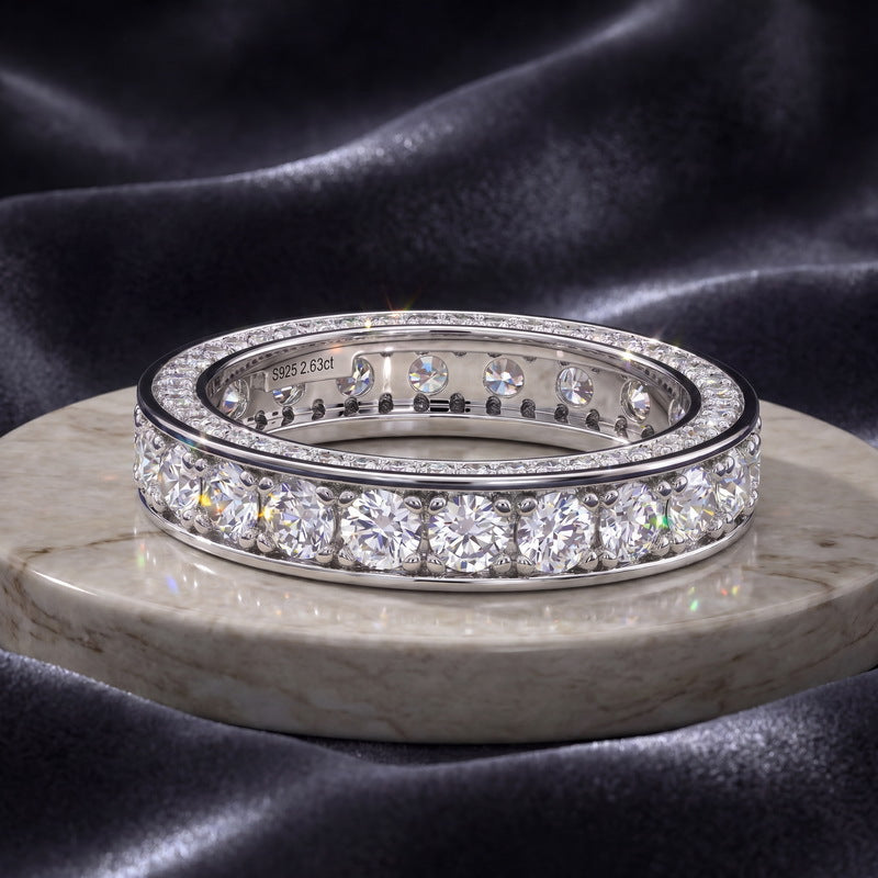 2.63CT lab grown diamond full eternity band ring sitting on marble and dark silk fabric.