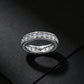 Frontal view of 2.63CT lab grown diamond three-sided eternity band ring on dark background.