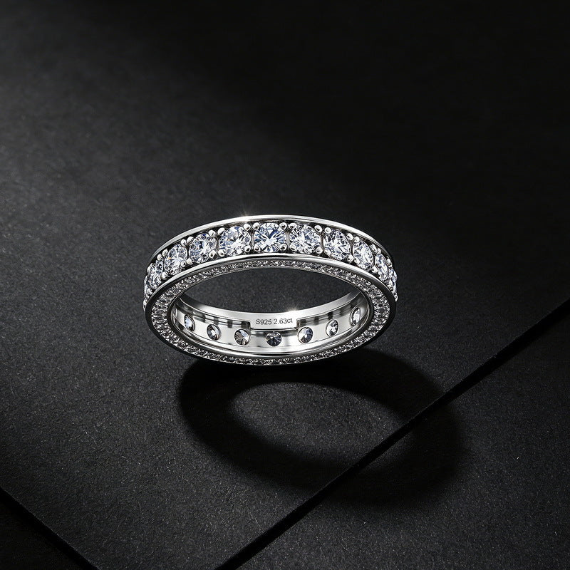 Frontal view of 2.63CT lab grown diamond three-sided eternity band ring on dark background.