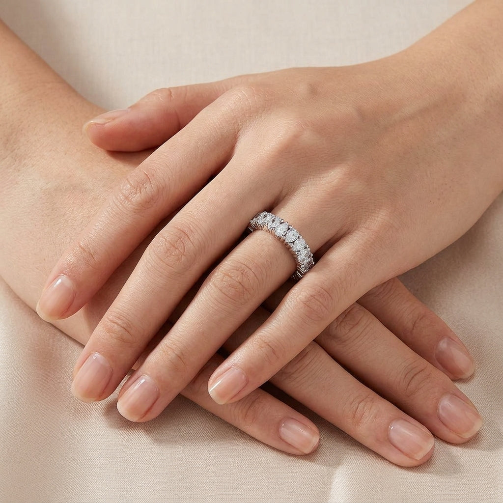 Close up view of hands showing 2.78 ctw pear cut lab grown diamond eternity ring