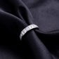 Angled side view showing channel setting profile of 2 ctw lab grown diamond eternity ring on black silk