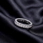 2 ctw channel set round lab grown diamond eternity wedding band resting flat on dark black silk