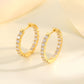 Yellow gold 2.1 CT round studs on neutral background. Alt: “2.1 CT Round Moissanite Earrings – 18K Yellow Gold.”