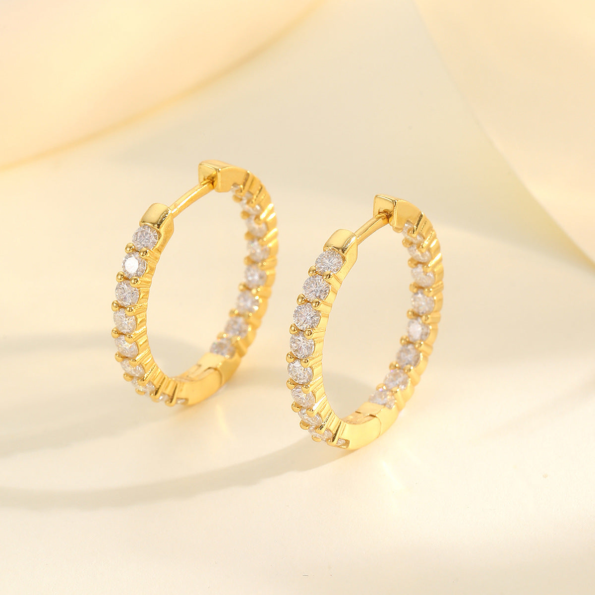 Yellow gold 2.1 CT round studs on neutral background. Alt: “2.1 CT Round Moissanite Earrings – 18K Yellow Gold.”