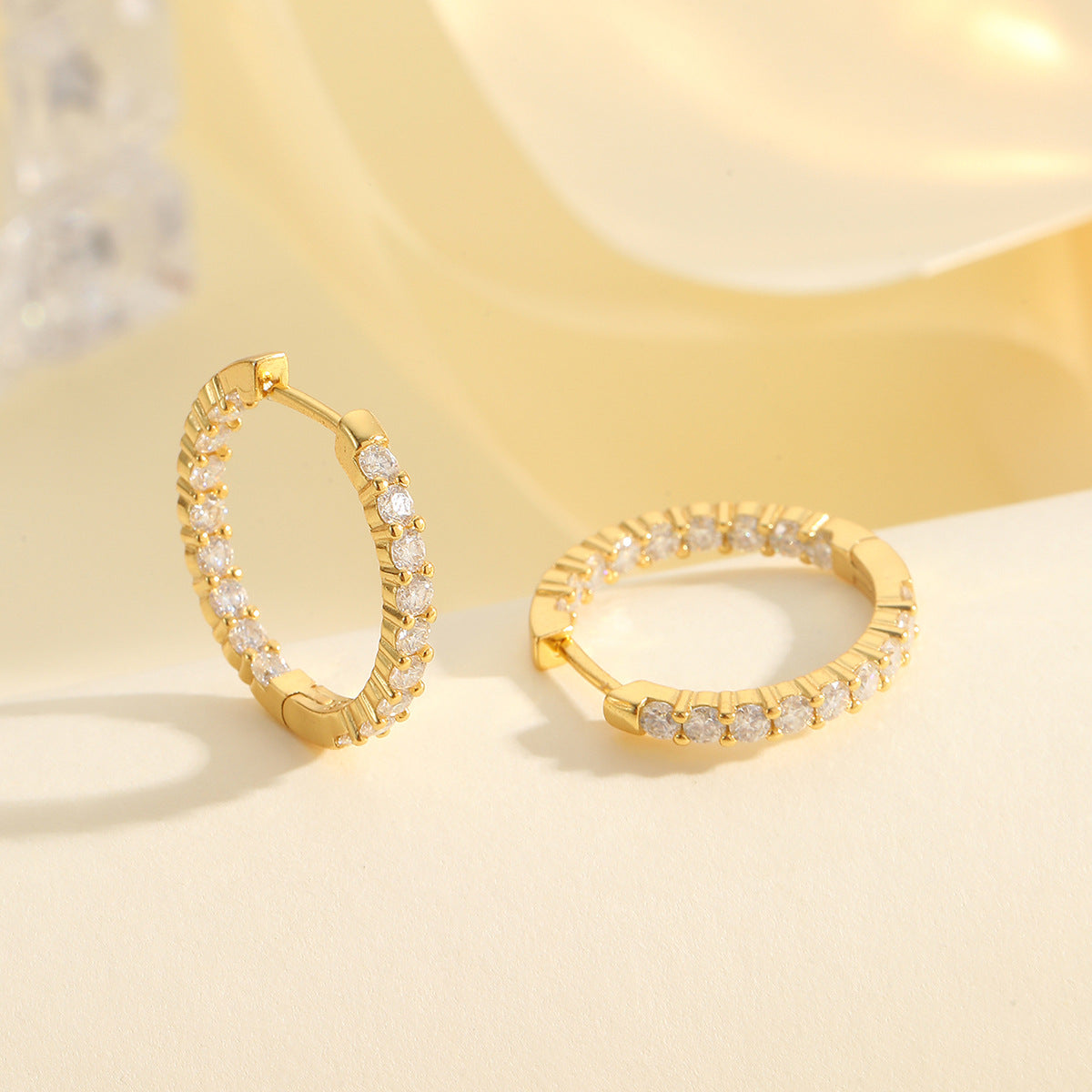 Yellow gold 2.1 CT round studs on neutral background. Alt: “2.1 CT Round Moissanite Earrings – 18K Yellow Gold.”