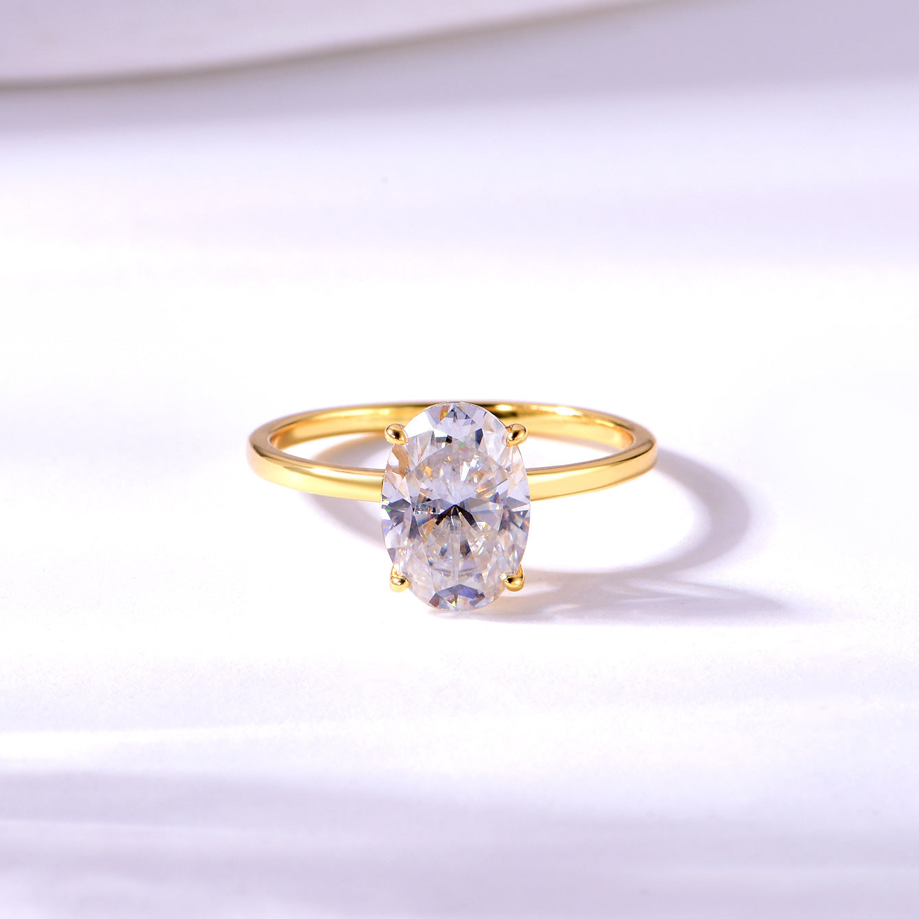 Yellow gold 2.5CT oval solitaire on neutral background. Alt: “2.5CT Oval Moissanite Solitaire – 18K Yellow Gold.”