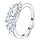 Angled view showing 2.5ct oval moissanite center stone flanked by pear-cut side accents.