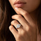 Close-up view of a model wearing 2.5ct oval cut moissanite past present future engagement ring.
