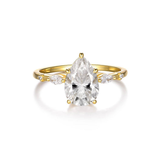  Yellow gold petal teardrop ring on soft romantic background. Alt: “2CT Petal-Shaped Teardrop Moissanite Ring – 18K Yellow Gold.”