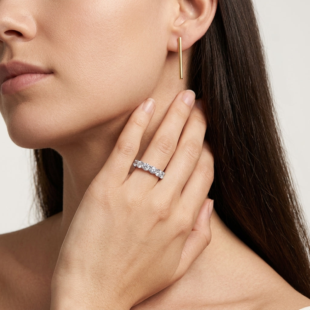 Model wearing 3.54ct round cut lab grown diamond full eternity band on ring finger.