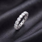 Side profile view showing shared prong setting of 3.84 ctw lab grown diamond eternity ring on black silk