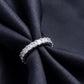 Angled view showing prong setting of 3.88 ctw asscher cut lab grown diamond eternity ring on black silk