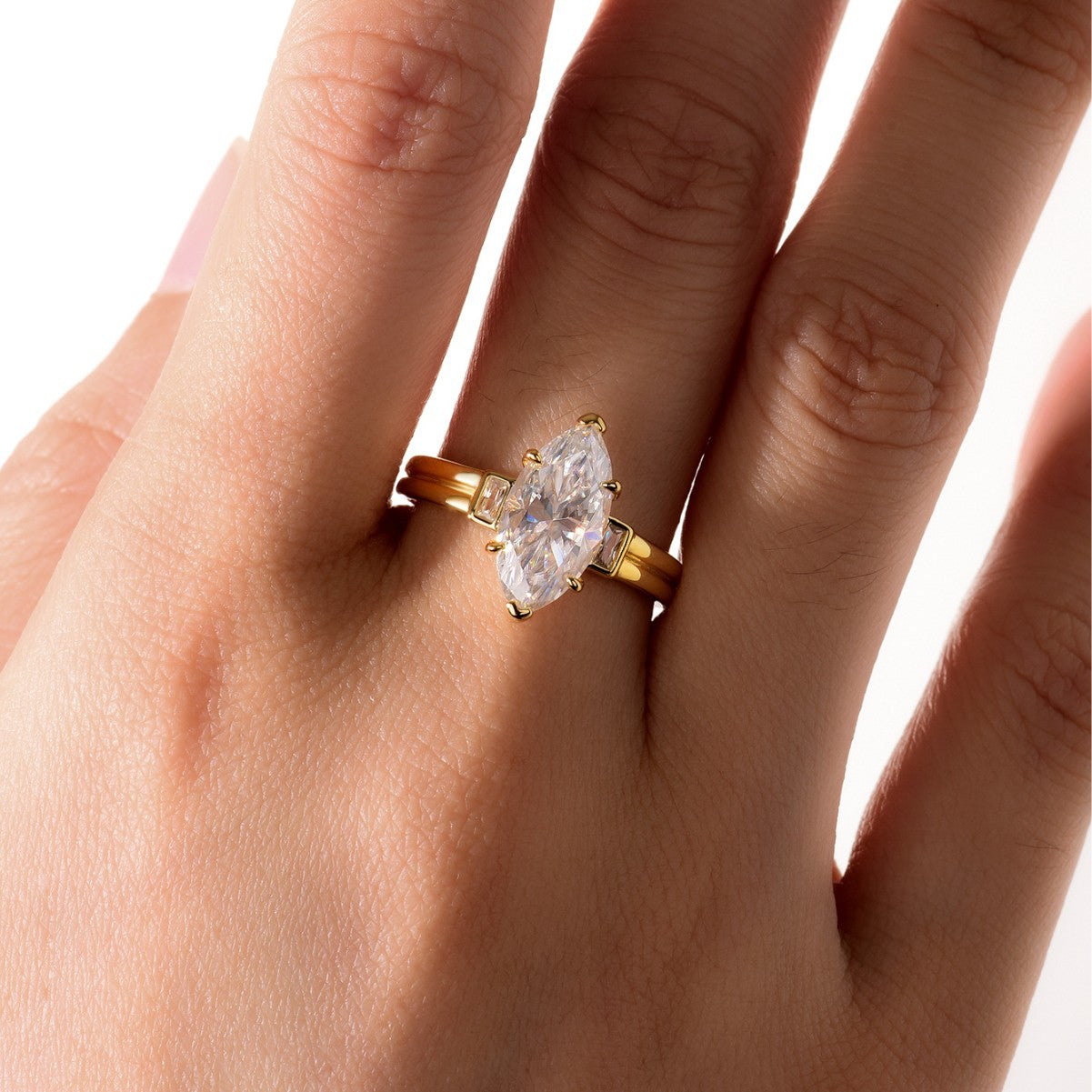 Yellow gold 3CT marquise moissanite ring on soft romantic background. Alt: “3CT Marquise Moissanite Engagement Ring – 18K Yellow Gold.”