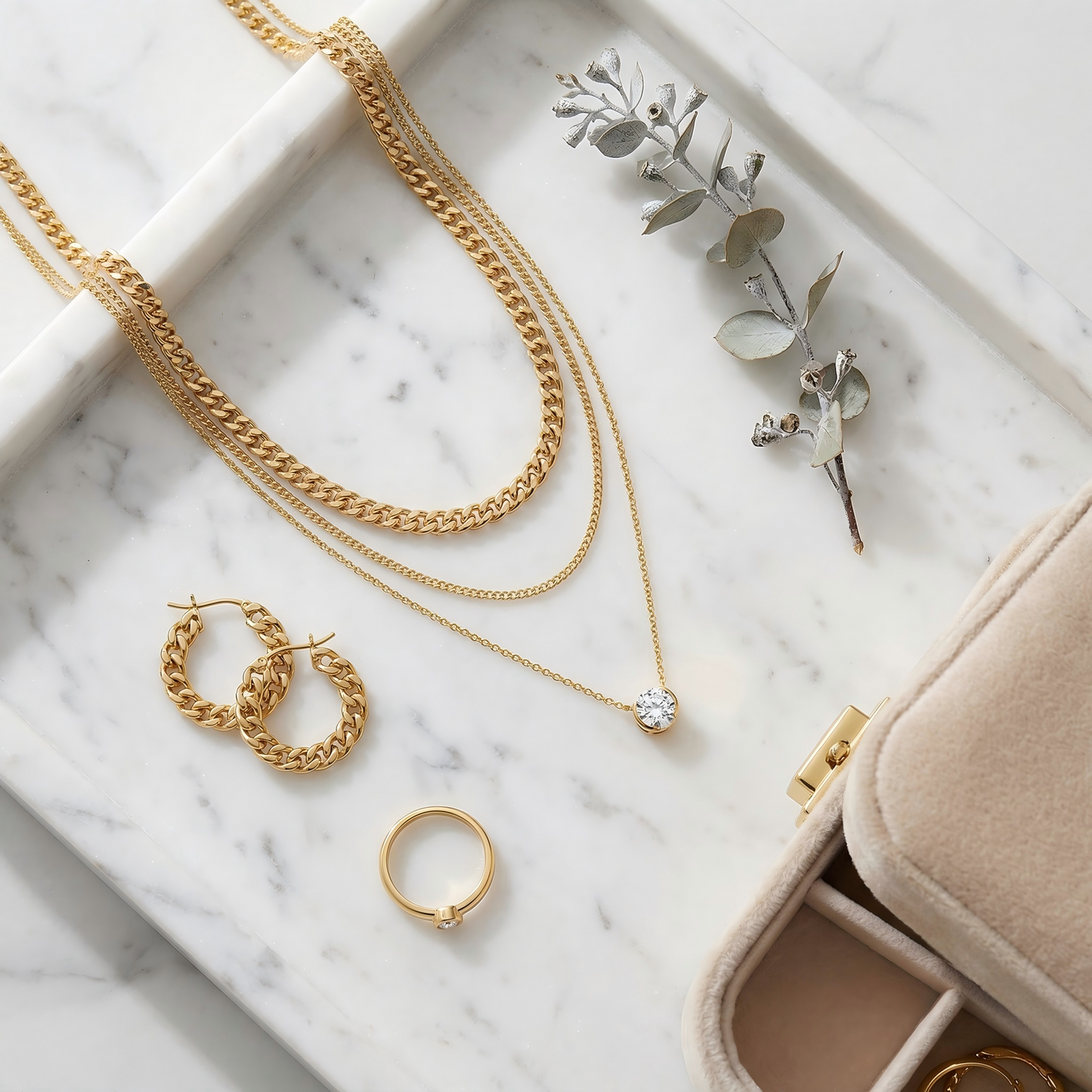 Top-down, necklaces on marble tray, styled with earrings, ring, dried flower, velvet box, warm soft tones, balanced composition, clean e-commerce aesthetic, high resolution.