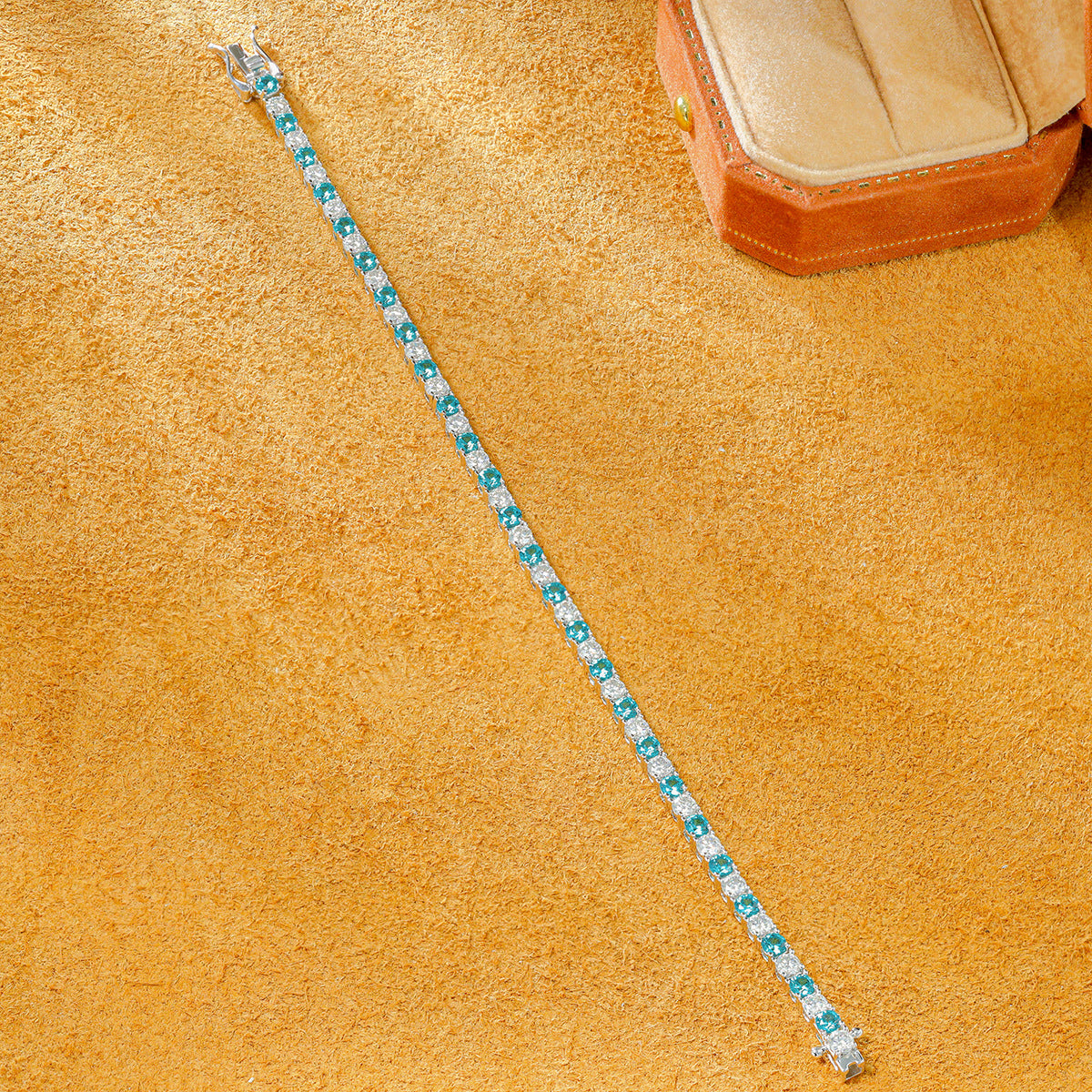 Straightened 3.0mm lab grown paraiba tourmaline and moissanite tennis bracelet showing alternating stones