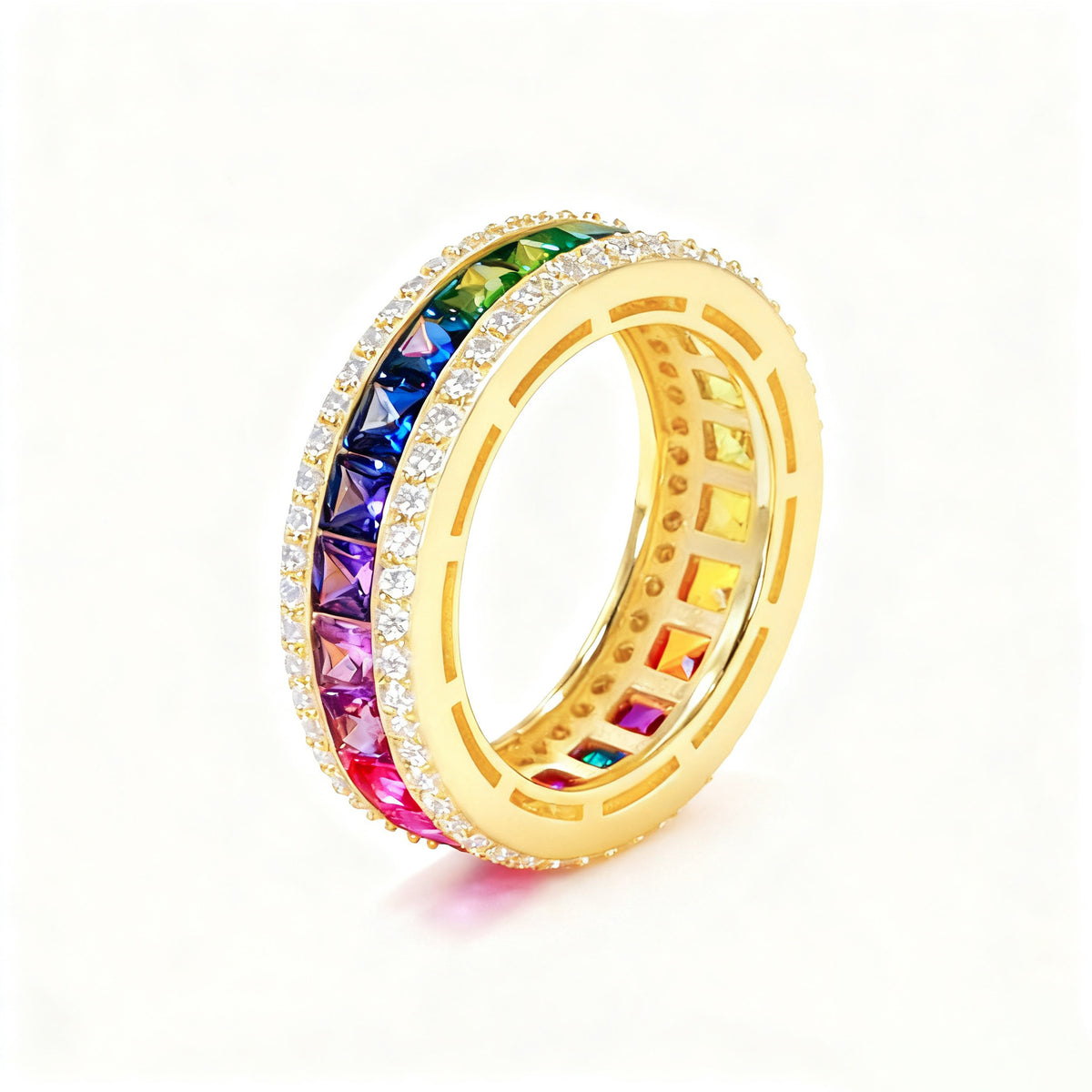 Gold 3mm princess cut rainbow channel-set eternity band ring with pave borders on white studio background